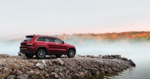 2019 Jeep Grand Cherokee on a rock embankment of a lake