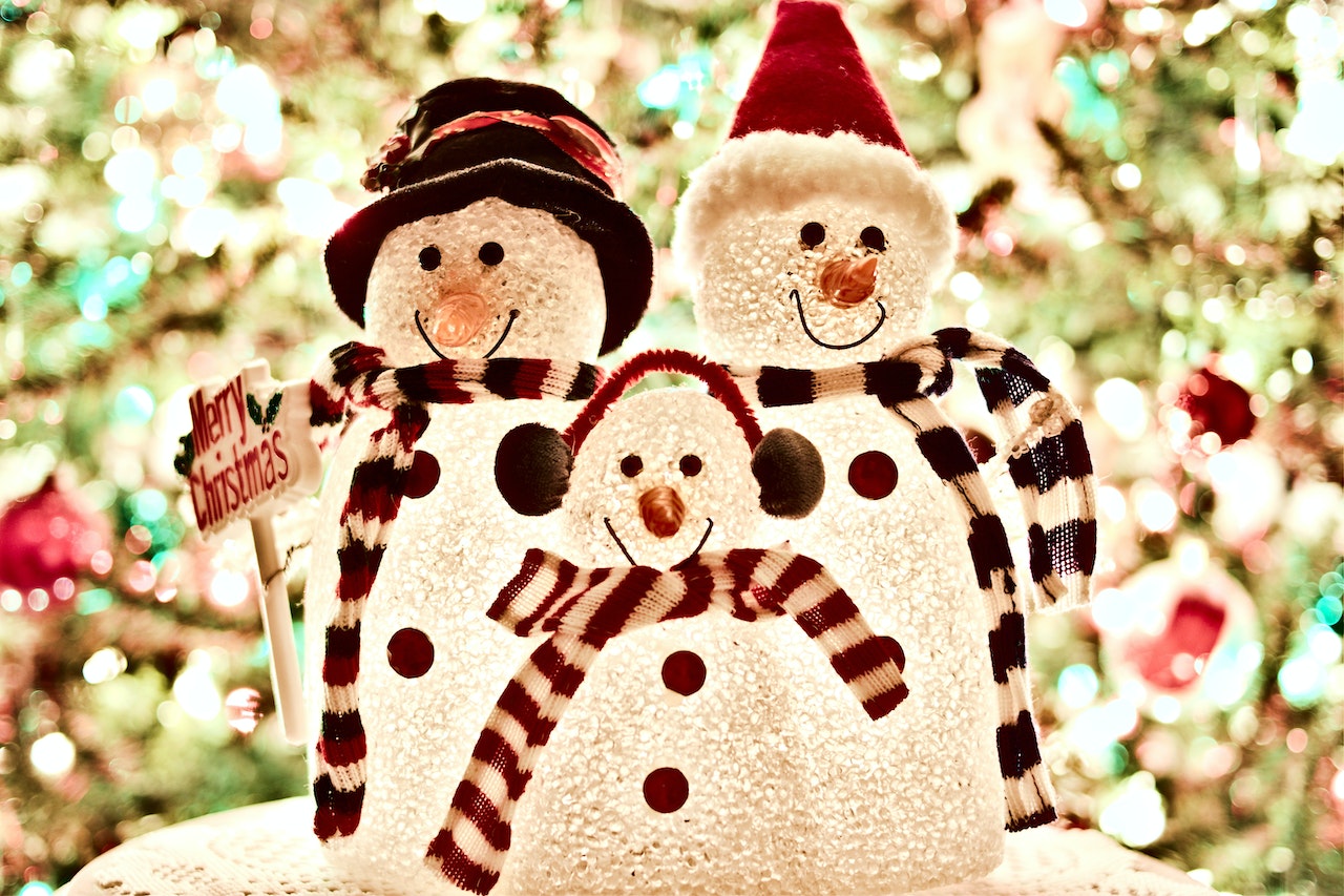 three snowmen in christmas attire