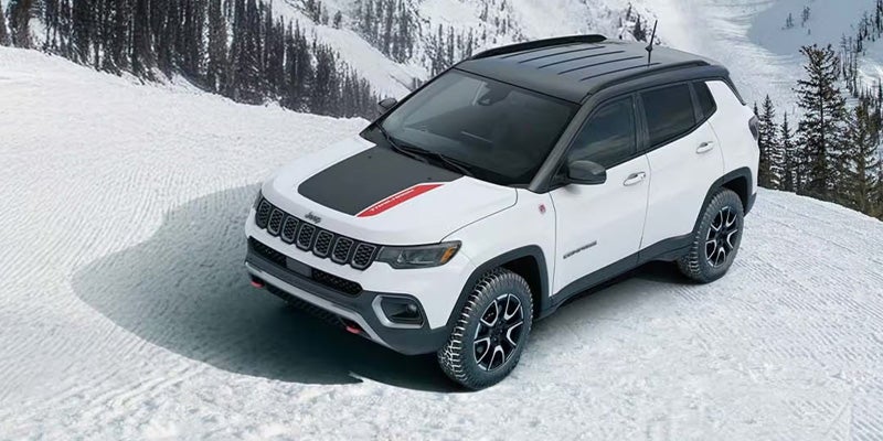 Jeep driving on snowy mountain terrain